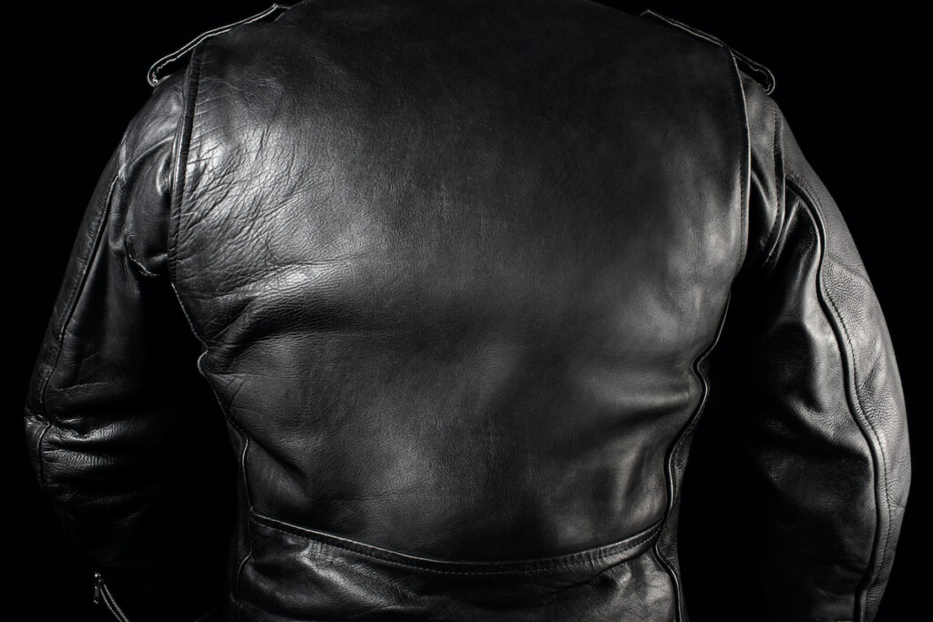 back of person wearing a black leather motorcycle jacket